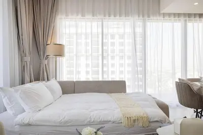 a bedroom with a bed and a large window at Mahogany 26 - 4BR 9PAX - Dubai Hills Park Peaceful in Dubai