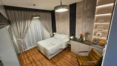 a bedroom with a bed and a table and a chair at Bella-Rose-Fully Furnished Cozy High Floor Amazing View in Dubai
