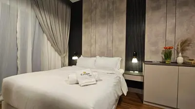a bedroom with a large white bed with towels on it at Bella-Rose-Fully Furnished Cozy High Floor Amazing View in Dubai