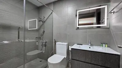 a bathroom with a toilet and a sink and a shower at Bella-Rose-Fully Furnished Cozy High Floor Amazing View in Dubai