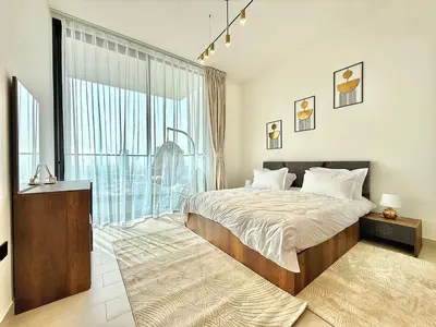 a bedroom with a large bed and a large window at Elegant and Stylish Retreat - Lavender Binghatti 1103 in Dubai