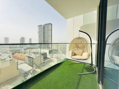 a room with a rattan chair on a balcony at Elegant and Stylish Retreat - Lavender Binghatti 1103 in Dubai