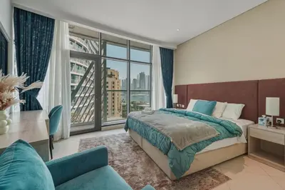 a bedroom with a bed and a large window at Luxury 2BR at Seven Palm Rooftop Pool&Beach Access in Dubai