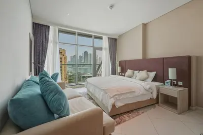 a large bedroom with a bed and a couch at Luxury 2BR at Seven Palm Rooftop Pool&Beach Access in Dubai