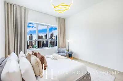 a bedroom with a bed and a large window at LUX The Armada Suite JLT in Dubai