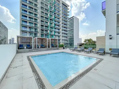 a swimming pool on the rooftop of a building at Sleek Modern Home in the Heart of JVC in Dubai