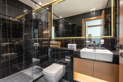 a bathroom with a toilet and a sink at Sleek Modern Home in the Heart of JVC in Dubai