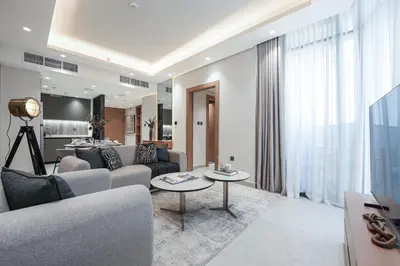 a living room with a couch and a table at Stylish 1 BR in Cloud Tower in Dubai