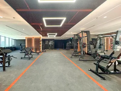 a gym with several treadmills and exercise equipment at Stylish 1 BR in Cloud Tower in Dubai