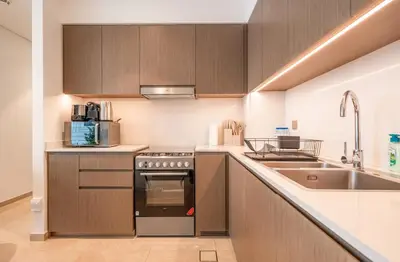 a kitchen with a sink and a stove top oven at Dream Apartment with Burj Khalifa & Fountain Views in Dubai