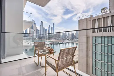a balcony with a table and chairs and a view of a city at Frank Porter - Beach Mansion in Dubai
