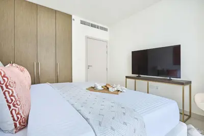 a bedroom with a bed with a flat screen tv at Frank Porter - Beach Mansion in Dubai