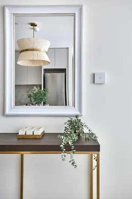 a mirror on a wall above a wooden table at Frank Porter - Beach Mansion in Dubai