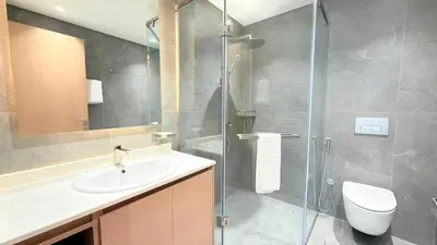 a bathroom with a sink and a glass shower at Cloud Tower 1br With Parking Pool Gym & Sports Facilities in Dubai