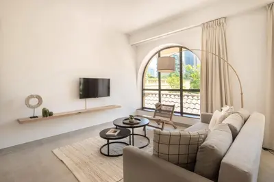 a living room with a couch and a window at Upgraded apartment just steps away from JBR beach in Dubai