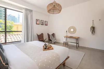 a bedroom with a large bed and a window at Upgraded apartment just steps away from JBR beach in Dubai