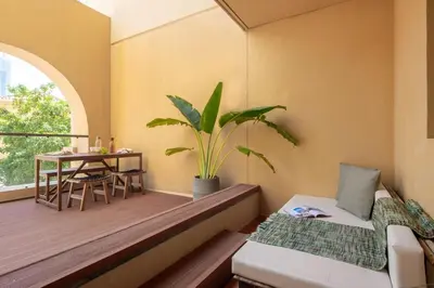 a balcony with a bed and a table with a plant at Upgraded apartment just steps away from JBR beach in Dubai