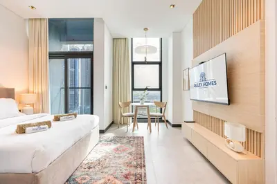 a hotel room with a bed and a table at Central Modern Studio with Floor to Ceiling Windows in Dubai