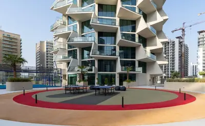 a building with tables in front of it at Elegant 1BR Haven at Binghatti Phantom in Dubai