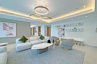 a living room with a couch and chairs and a chandelier at Miami Vibes - 1BR with Private Beach, Sea, Palm View in Dubai