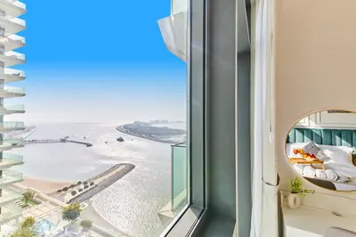 a view of the beach from a hotel room window at Miami Vibes - 1BR with Private Beach, Sea, Palm View in Dubai