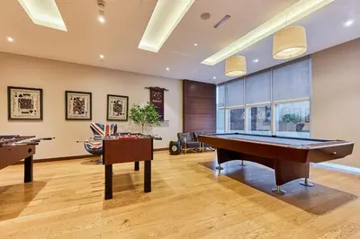 a room with a pool table and two tables at Luxury 1BR on Marina Walk, Sea & Palm View-6 Sleep in Dubai