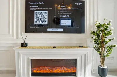 a fireplace with a tv above it in a living room at Luxury 1BR on Marina Walk, Sea & Palm View-6 Sleep in Dubai