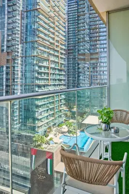 a balcony with a table and chairs and a large window at Luxury 1BR on Marina Walk, Sea & Palm View-6 Sleep in Dubai
