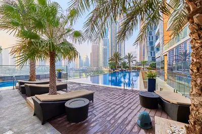 a resort with a pool and palm trees and buildings at FENDI 2BR- 67 Floor Sea, Atlantis & Dubai Eye View in Dubai