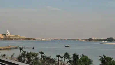 a large body of water with a boat in it at Palm Jumeirah gem with direct beach access in Dubai