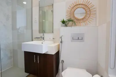 a bathroom with a sink and a mirror at Palm Jumeirah gem with direct beach access in Dubai