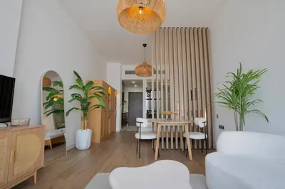 a living room with a table and chairs at Palm Jumeirah gem with direct beach access in Dubai
