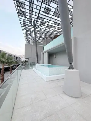 a building with a swimming pool and a glass ceiling at Modern 2BR House , Pool , 3 Baths, Balconies in Dubai