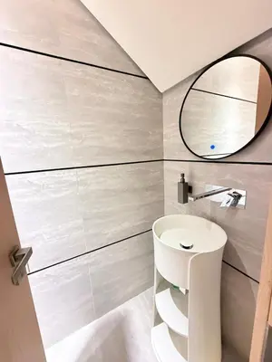 a bathroom with a white sink and a mirror at Modern 2BR House , Pool , 3 Baths, Balconies in Dubai