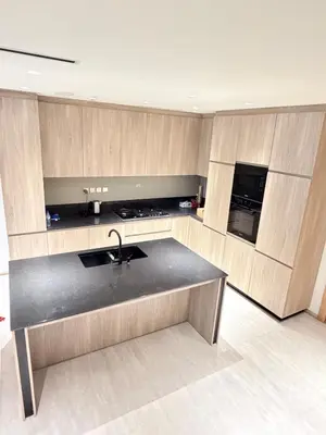 a kitchen with a sink and a counter top at Modern 2BR House , Pool , 3 Baths, Balconies in Dubai