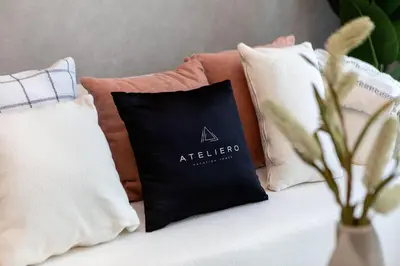 a group of pillows on a couch with a vase at Wonderful 1BR Apartment at East Crest in Dubai
