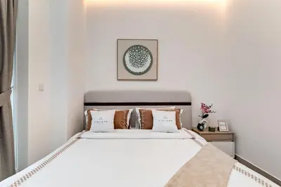 a bedroom with a large white bed with pillows at Wonderful 1BR Apartment at East Crest in Dubai