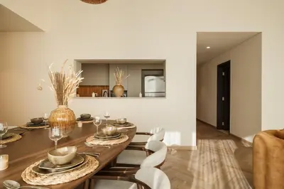 a dining room with a wooden table and chairs at Seraya Residences at Downtown Views 1 in Dubai