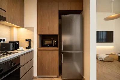 a kitchen with a stainless steel refrigerator in a kitchen at Seraya Residences at Downtown Views 1 in Dubai