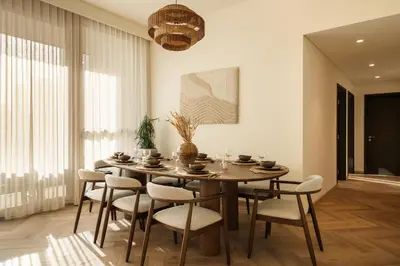 a dining room with a table and chairs at Seraya Residences at Downtown Views 1 in Dubai