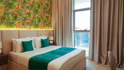 a hotel room with a bed and a large window at Elegant 2BR Canal & Burj Khalifa View 1 in Dubai
