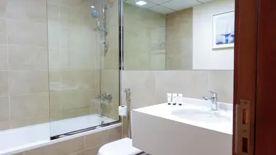 a bathroom with a sink and a shower and a toilet at Modern 3BR Full Canal & Burj Khalifa View 2 in Dubai