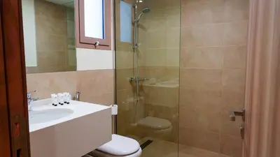 a bathroom with a shower and a sink and a toilet at Modern 3BR Full Canal & Burj Khalifa View 2 in Dubai
