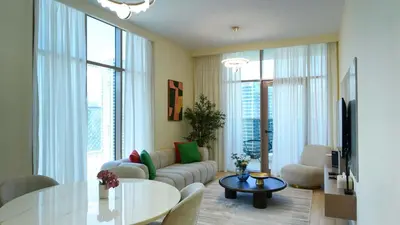 a living room with a couch and a table at Stunning 2BR Canal View & Burj Khalifa 3 in Dubai