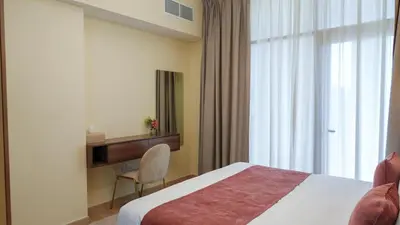 a hotel room with a bed and a window at Stunning 2BR Canal View & Burj Khalifa 3 in Dubai