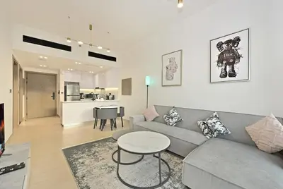 a living room with a couch and a table at Stunning 1 br modern luxury residence at JVC in Dubai