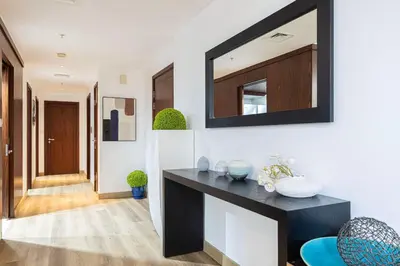 a living room with a black counter and a mirror at Burj Khalifa and Fountain View 3BR in Dubai