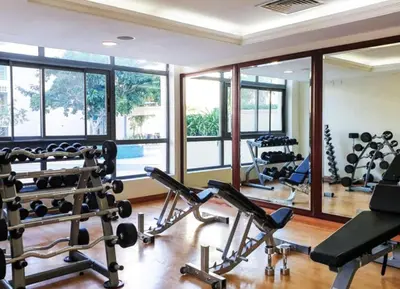 a gym with a lot of exercise equipment and windows at Vacationer l Spacious Studio l Canal View l The Greens in Dubai
