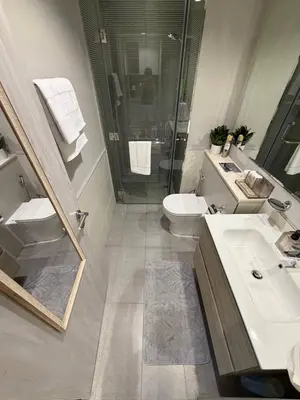 a bathroom with a sink and a toilet and a shower at Zada Tower 1 Bedroom Apartment in Business Bay in Dubai