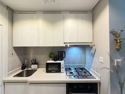 a kitchen with a sink and a stove top oven at Zada Tower 1 Bedroom Apartment in Business Bay in Dubai